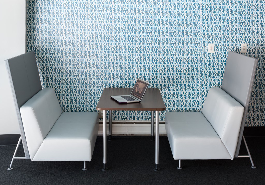 two chairs and a table with a laptop on it