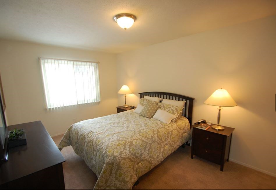 a bedroom with a bed and two night stands