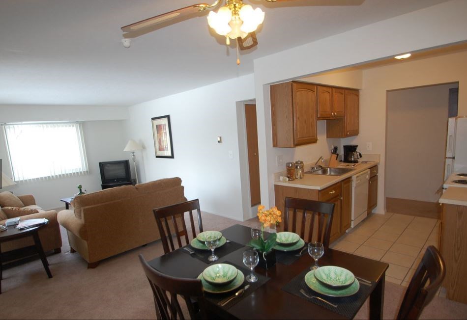 a dining room and living room with a table and chairs