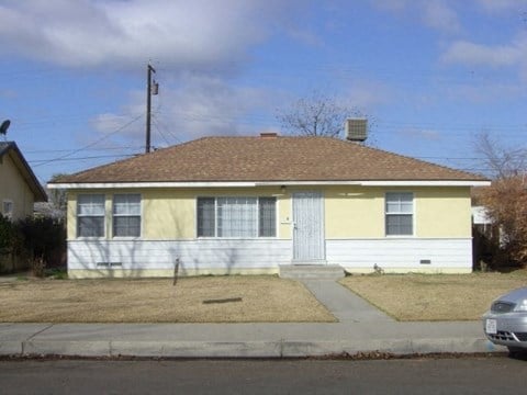 a yellow and on the side of the street