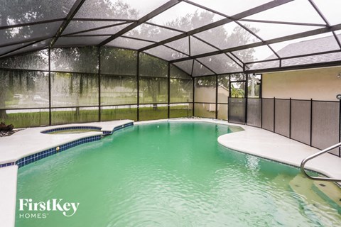 A pool inside a house with FirstKey Homes written on the side.