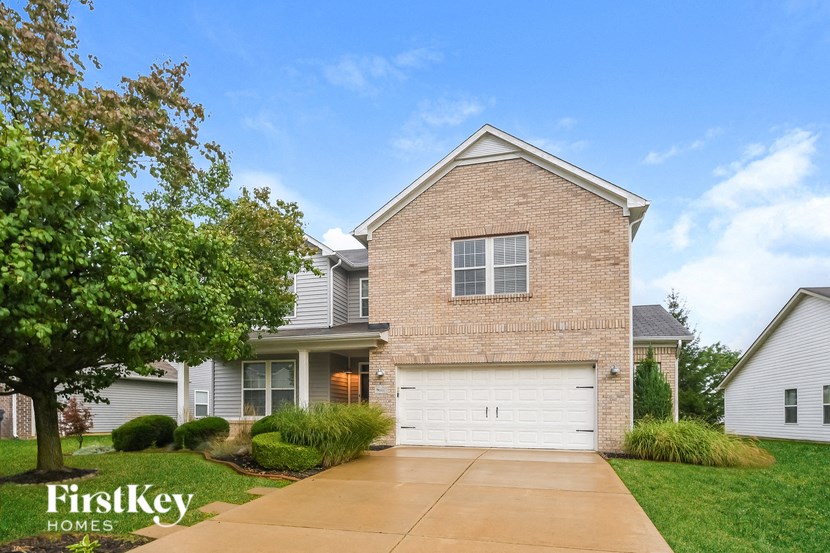 a large brick house with a white garage door