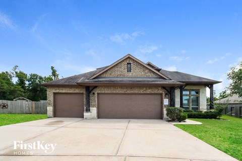 a house with a garage door in front of a lawn