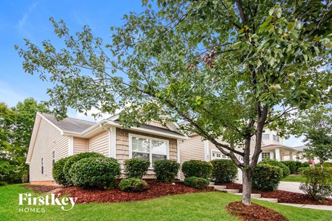 A house with a tree in front of it.