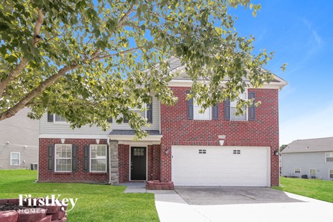 a red brick house with a white garage door