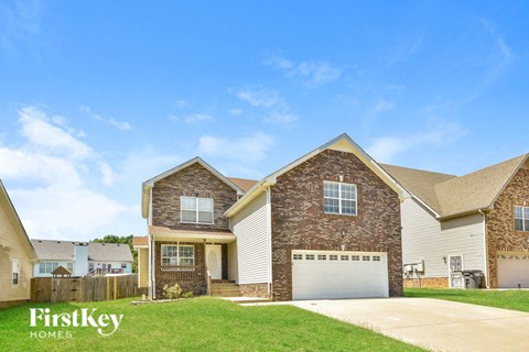 a house with a garage door and a lawn
