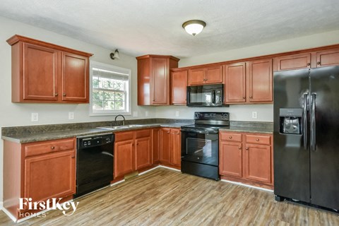 a kitchen with wooden cabinets and black appliances