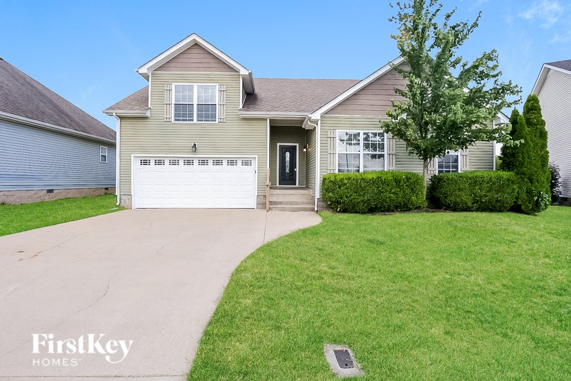 a beige house with a white garage door