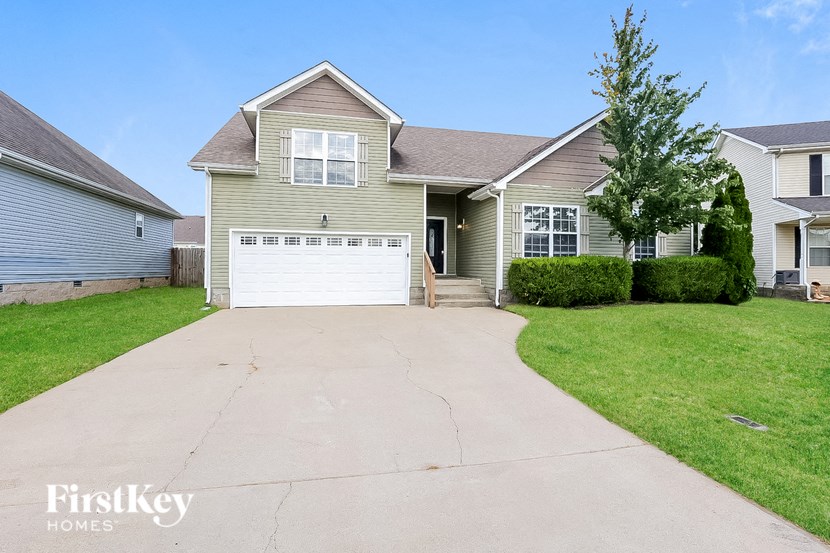 a beige house with a white garage door
