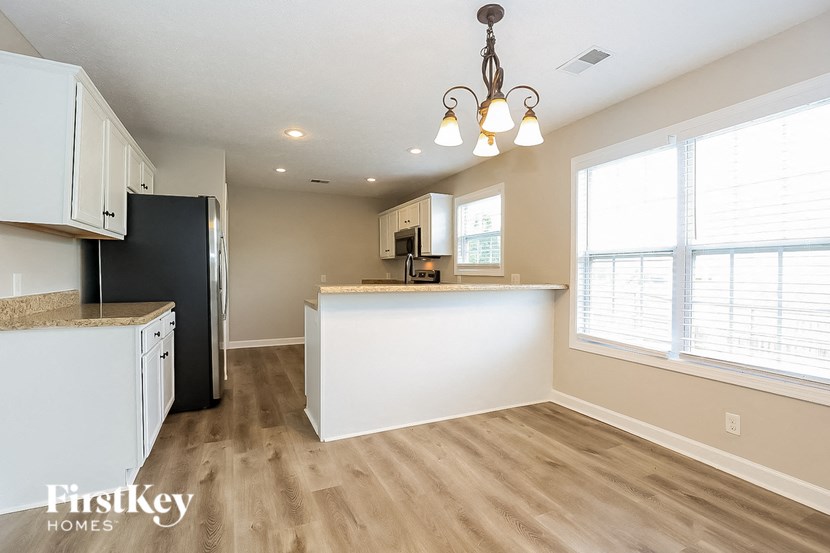 the kitchen is open to the dining room and living room