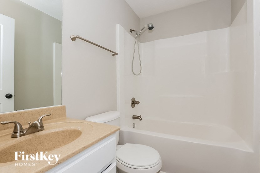 a bathroom with a sink and a shower and a toilet