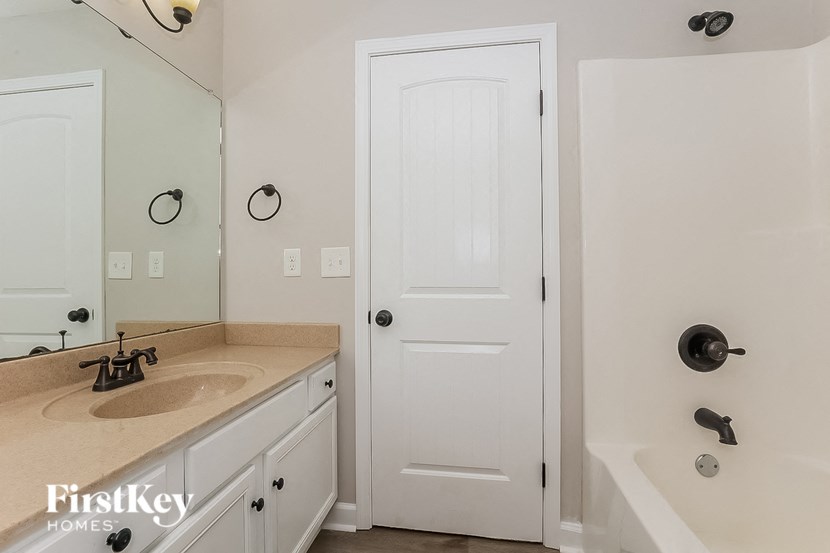 a bathroom with a sink and a white door