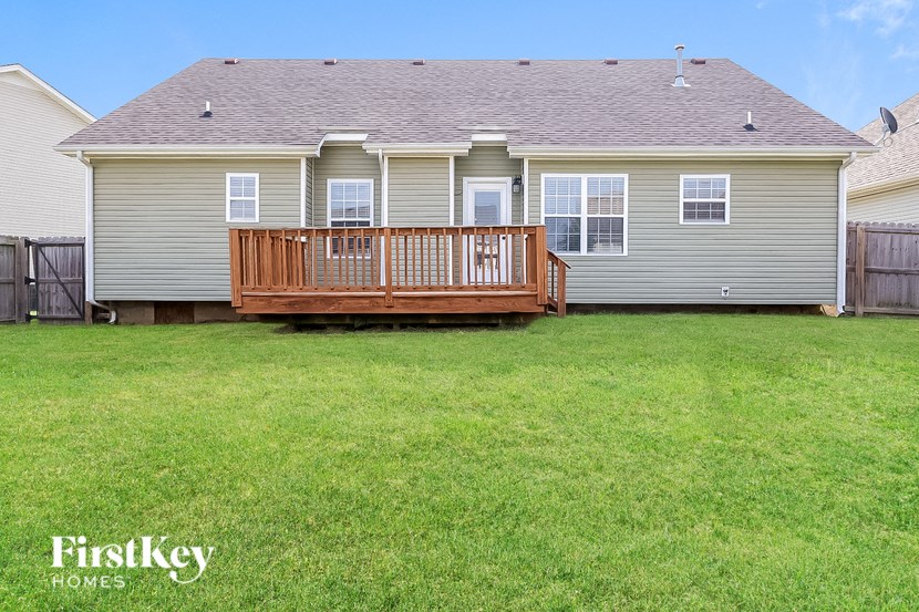 a backyard with a deck and a house