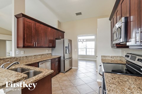 a kitchen with granite counter tops and stainless steel appliances