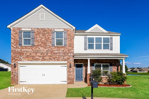 a red brick house with a white garage door