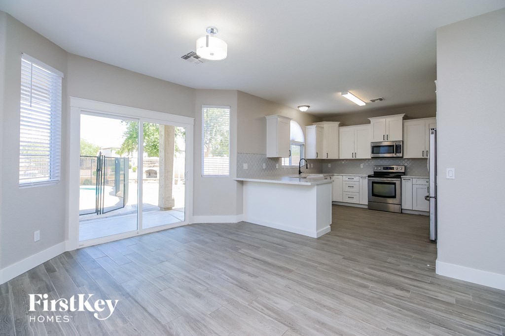 A kitchen with a white counter top and a refrigerator.
