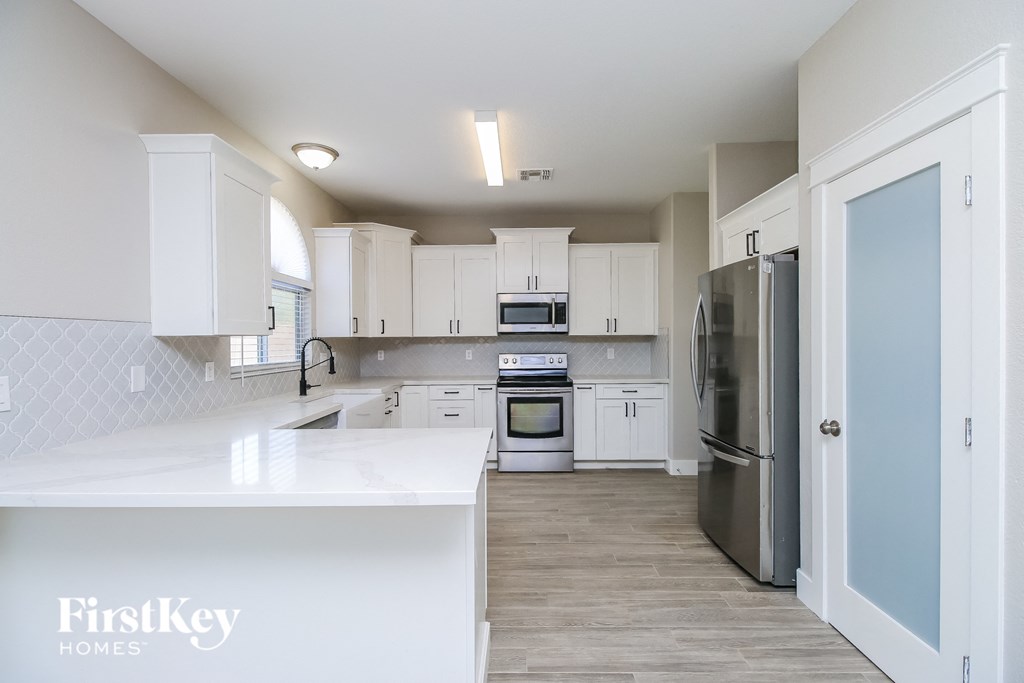 A kitchen with a FirstKey Homes logo on the counter.