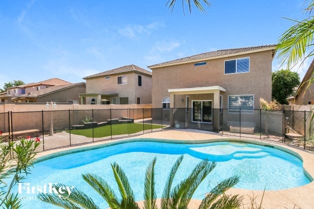 A house with a pool in the backyard.
