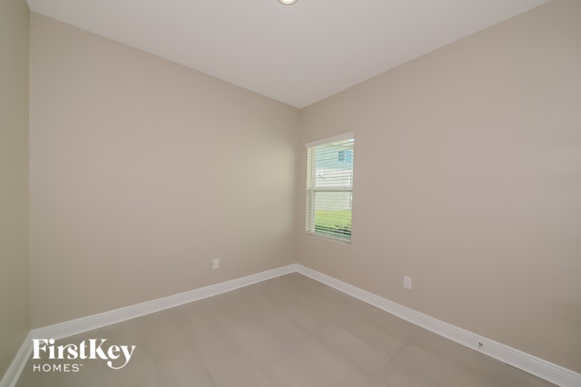 A room with a FirstKey Homes logo on the bottom left corner.
