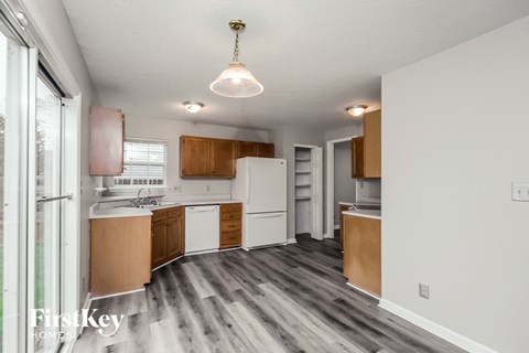 A kitchen with wooden cabinets and a white refrigerator.