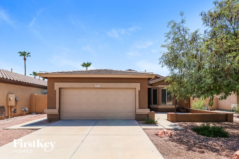 A house with a brown garage door and a brown roof.