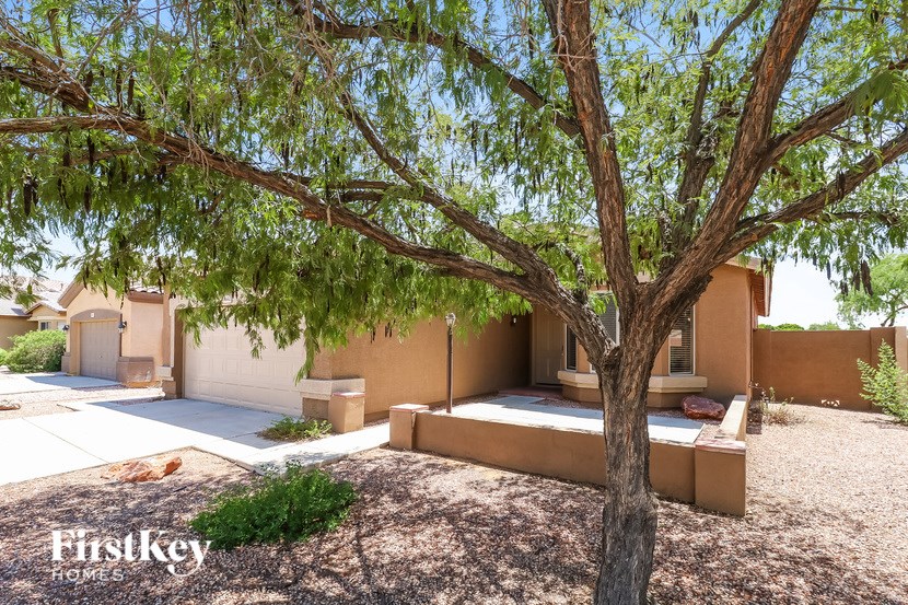 A tree in front of a house with the words "FirstKey Homes" on the bottom left.