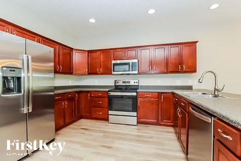 A kitchen with wooden cabinets and stainless steel appliances.