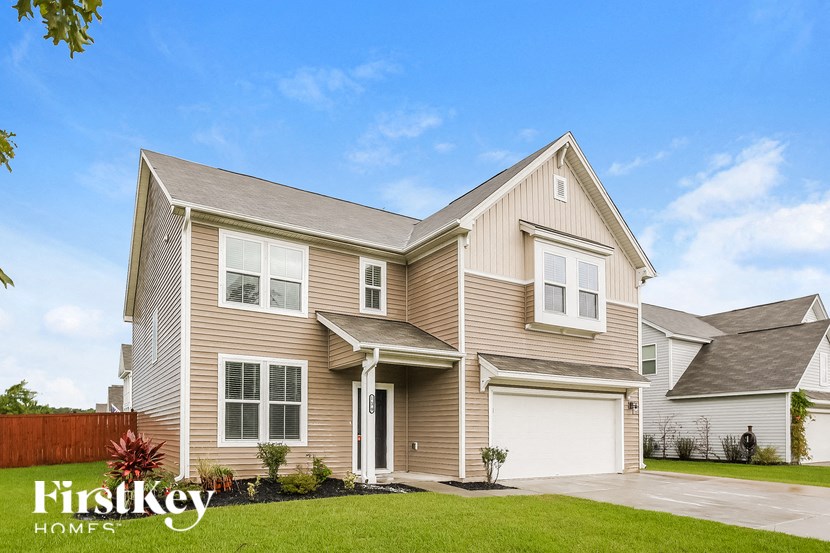 A house with a brown and beige exterior is showcased in the image.