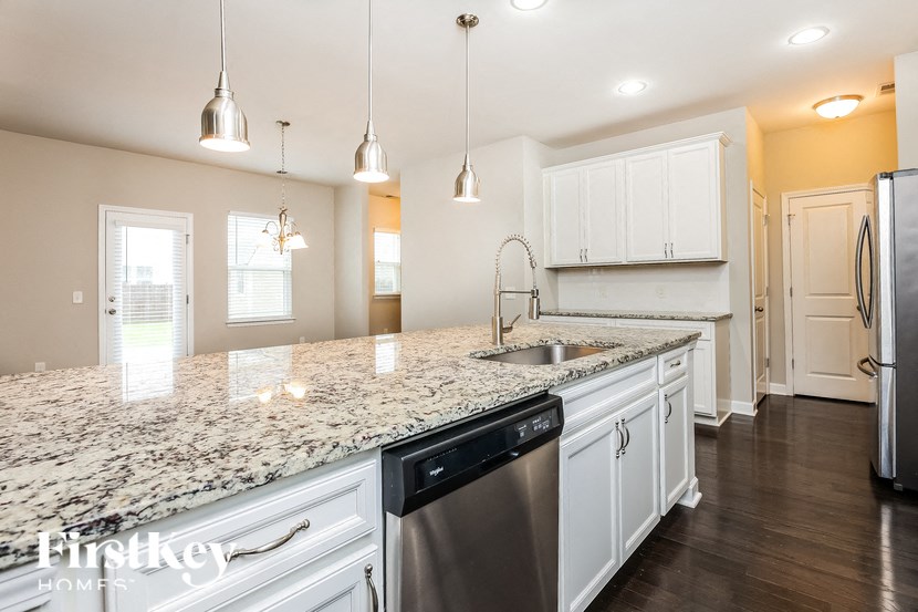 A kitchen with granite countertops and stainless steel appliances.