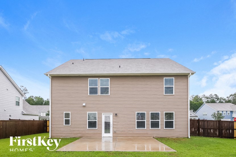 A house with a brown siding and a white door is for sale.