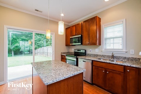 a kitchen with granite counter tops and wooden cabinets