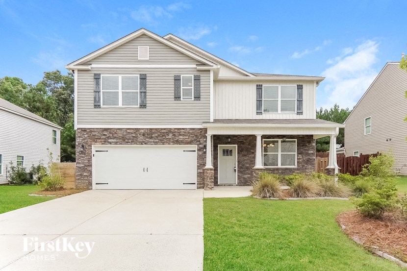 A two-story house with a garage is for sale.