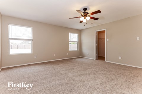 the master bedroom is spacious and has a ceiling fan