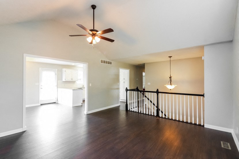 the view of the living room from the top of the stairs in a new home