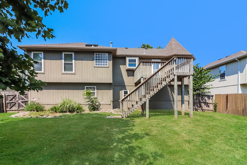the back of a house with a wooden deck
