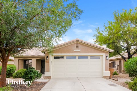 A house with a garage is for sale.