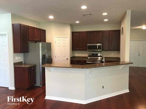 A kitchen with brown cabinets and a white island.