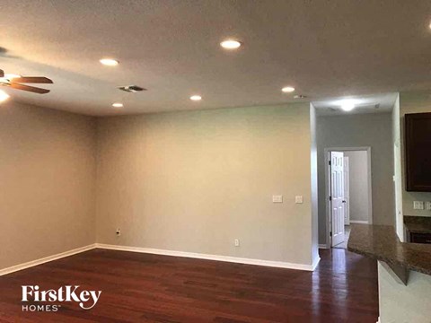 A room with wooden floors and a ceiling fan.