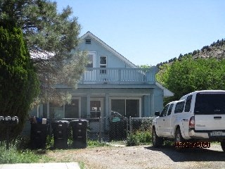 a white truck parked in front of a house