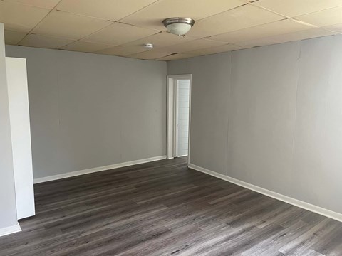 A room with a wooden floor and a white ceiling.