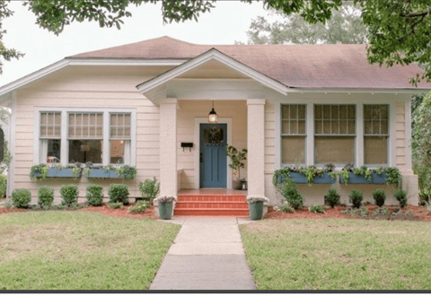 A small house with a blue door and windows.