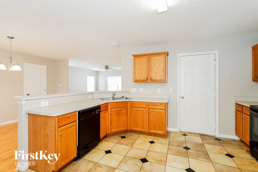 a kitchen with wooden cabinets and a white counter top