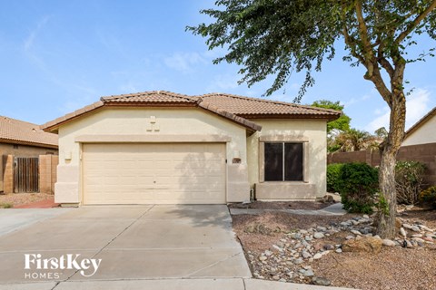 a house with a white garage door and a tree