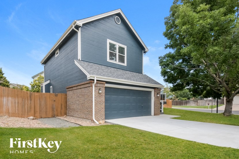 a blue house with a driveway and a blue garage door