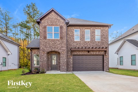 A brick house with a garage door and a window.