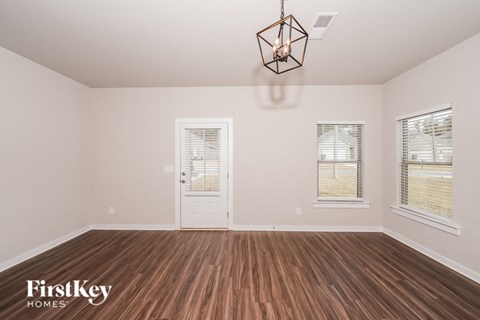 A room with wooden floors and a white door.