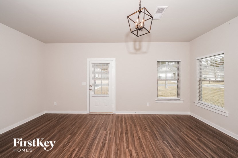 A room with wooden floors and a white door.