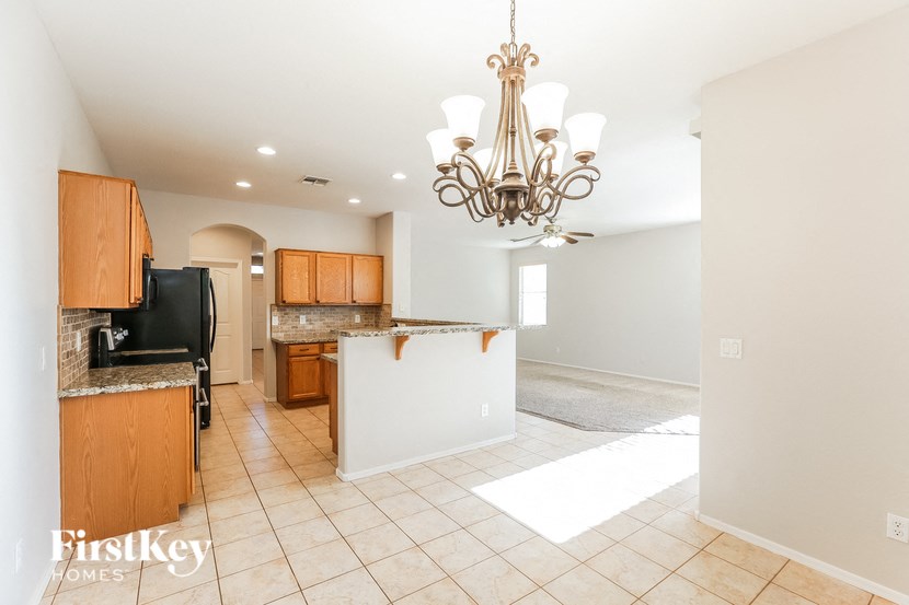 A kitchen with a chandelier hanging from the ceiling.