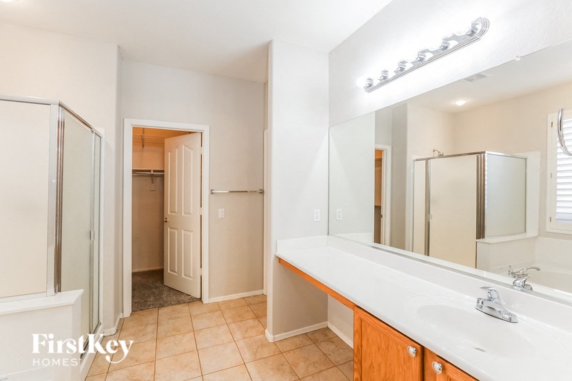 A bathroom with a white sink and a mirror.