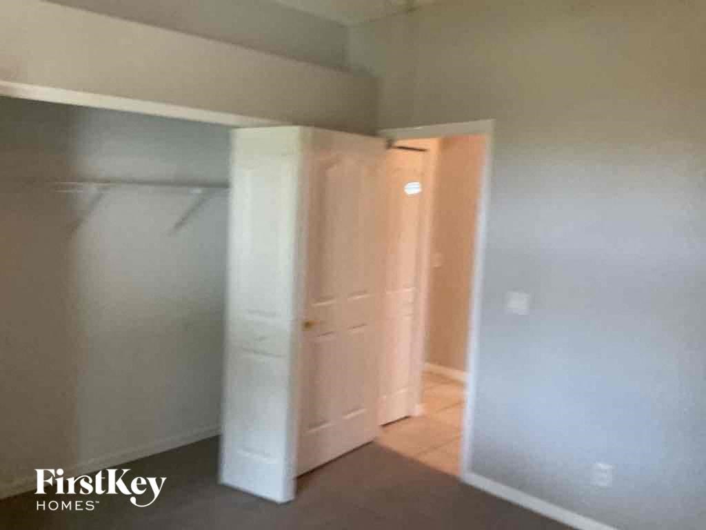 A room with a white door and a white wall.